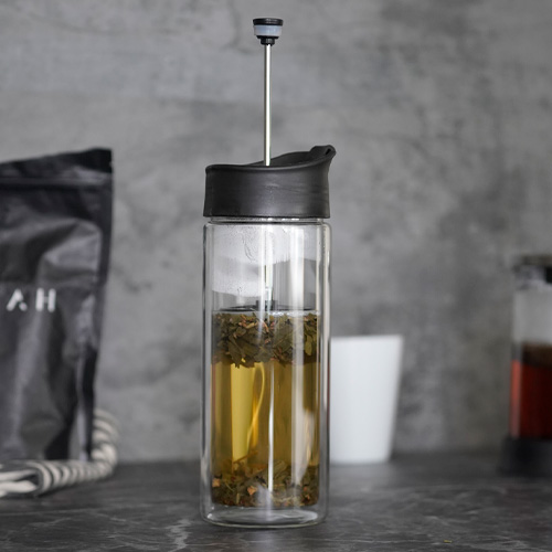 Termo con doble pared de vidrio, tapa de plástico enroscable, boquilla de seguridad a presión y filtro de plástico con rejilla. NEGRO